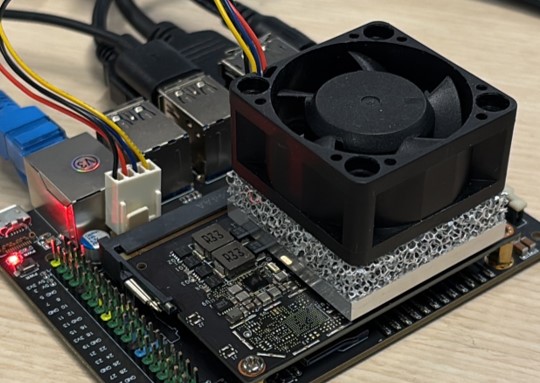 Photo of a metal foam heat sink with a fan mounted on a circuit board