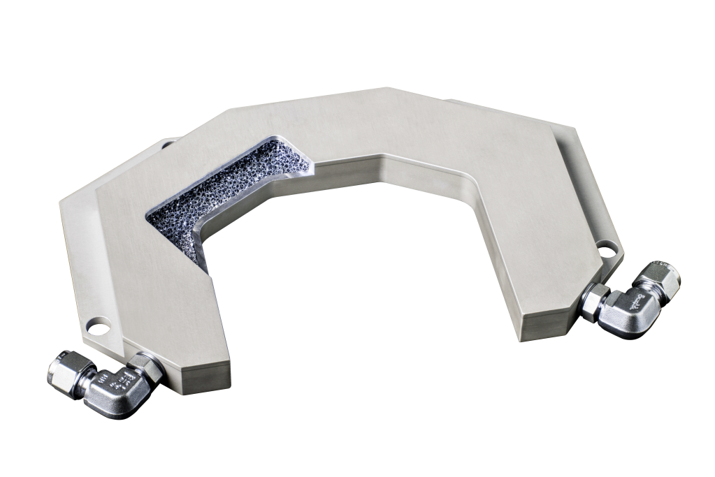 A photo of an aluminum cold plate with conformal geometry, and a piece cut out to show the foam structure inside